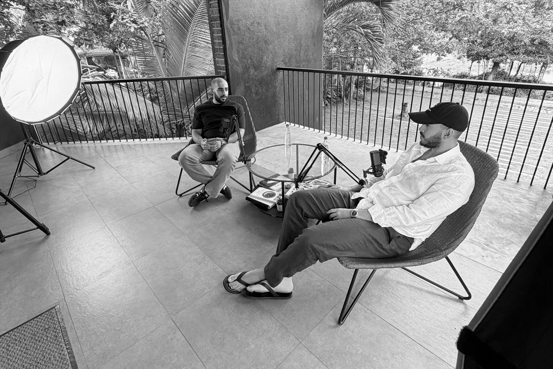 The founders recording on set with a light and two microphones