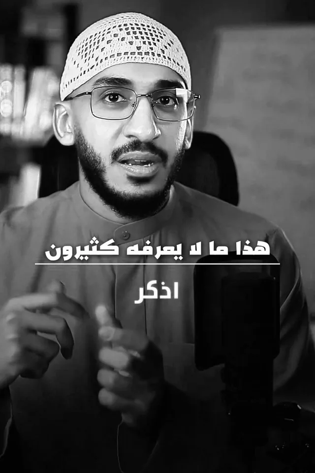 Ali Alhamed in a white cap, speaking to the camera