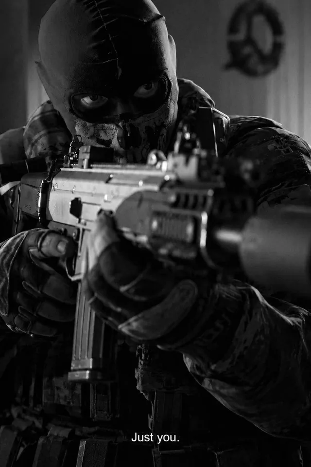 Masked soldier aiming a rifle